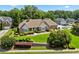 Well-maintained brick home with a manicured lawn and mature trees providing shade and curb appeal at 2012 Arbor Springs Way, Buford, GA 30519