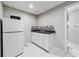 Basement kitchenette with white appliances and tiled floor at 2012 Arbor Springs Way, Buford, GA 30519