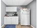 Close up view of the kitchenette with white cabinets, sink, microwave, and fridge at 2012 Arbor Springs Way, Buford, GA 30519