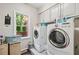 Bright laundry room with modern appliances, natural light, and built in cabinetry at 2012 Arbor Springs Way, Buford, GA 30519