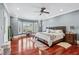 Spacious main bedroom with hardwood floors, large windows, and ceiling fan at 2012 Arbor Springs Way, Buford, GA 30519