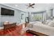 Spacious main bedroom with hardwood floors, large windows, and a modern ceiling fan at 2012 Arbor Springs Way, Buford, GA 30519