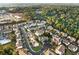 Aerial view showcases the neighborhood's location near wooded areas and commercial properties at 303 Fox Overlook, Woodstock, GA 30188