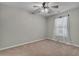 Neutral bedroom with a ceiling fan, a window with curtains, and carpet flooring at 303 Fox Overlook, Woodstock, GA 30188