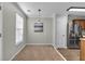 Dining area featuring modern pendant lighting and stainless steel refrigerator at 303 Fox Overlook, Woodstock, GA 30188