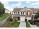 Scenic view of townhomes with lush green lawns, mature trees, and a peaceful setting at 303 Fox Overlook, Woodstock, GA 30188
