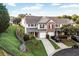 Scenic view of townhomes with lush green lawns, mature trees, and a peaceful setting at 303 Fox Overlook, Woodstock, GA 30188