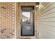 Front door with brick and vinyl siding and view of the neighborhood at 303 Fox Overlook, Woodstock, GA 30188