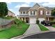 A well maintained townhome with a charming front yard, attached garage, and inviting facade at 303 Fox Overlook, Woodstock, GA 30188