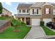 Well-maintained townhome with a charming front yard, attached garage, and inviting facade at 303 Fox Overlook, Woodstock, GA 30188
