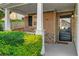 Inviting front porch with brick accents, white columns, and well-manicured landscaping at 303 Fox Overlook, Woodstock, GA 30188