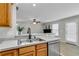 Kitchen sink and dishwasher with view of living room and fireplace at 303 Fox Overlook, Woodstock, GA 30188