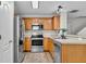 Kitchen featuring stainless steel appliances, wood cabinets, and tiled floor at 303 Fox Overlook, Woodstock, GA 30188