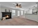 Open living room with fireplace and view to kitchen area at 303 Fox Overlook, Woodstock, GA 30188