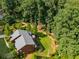 Aerial view of the home featuring a deck with umbrella and large mature trees at 278 Shire Way, Lawrenceville, GA 30044