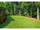 Spacious green backyard featuring mature trees and lush landscaping around the perimeter at 278 Shire Way, Lawrenceville, GA 30044
