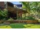 Beautiful backyard featuring a deck with string lights and a stone retaining wall at 278 Shire Way, Lawrenceville, GA 30044