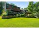 Expansive green backyard with a deck, stone retaining wall and access to the house at 278 Shire Way, Lawrenceville, GA 30044