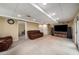 Finished basement with carpeted floor and a large television with speakers and an adjacent sitting area at 278 Shire Way, Lawrenceville, GA 30044