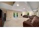 Finished basement area with plush carpeting, recessed lighting, and sliding glass doors to the outside at 278 Shire Way, Lawrenceville, GA 30044