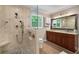 Bathroom featuring a tiled shower with a built-in seat and a double vanity at 278 Shire Way, Lawrenceville, GA 30044