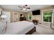 Bright bedroom with a ceiling fan, TV, and a window view at 278 Shire Way, Lawrenceville, GA 30044