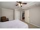 Bedroom with light-grey walls and carpet, and a ceiling fan, closet and adjacent room entrance at 278 Shire Way, Lawrenceville, GA 30044