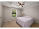 Cozy bedroom featuring neutral walls, a ceiling fan, plush carpet and a sun-filled window at 278 Shire Way, Lawrenceville, GA 30044