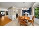 Bright dining area near kitchen featuring wainscoting, hardwood floors, and updated light fixtures at 278 Shire Way, Lawrenceville, GA 30044