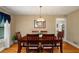 Traditional dining room with hardwood floors, chair rail, and a decorative chandelier at 278 Shire Way, Lawrenceville, GA 30044