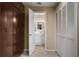 Hallway that leads to a full bath with white vanity and cabinets for storage at 278 Shire Way, Lawrenceville, GA 30044