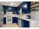 Charming kitchen with white subway tile backsplash, stainless steel appliances and open shelving at 278 Shire Way, Lawrenceville, GA 30044