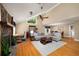 Open-concept living room features a stone fireplace, hardwood floors, and natural light at 278 Shire Way, Lawrenceville, GA 30044
