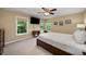 Spacious bedroom featuring two windows, ceiling fan, and neutral carpet at 278 Shire Way, Lawrenceville, GA 30044