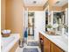 Bright bathroom with a walk-in closet, a soaking tub and a vanity with sink at 3198 Liberty Commons Dr, Kennesaw, GA 30144