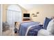 Bright bedroom with soft natural light features an arched window, neutral tones, and cozy decor creating a tranquil retreat at 3198 Liberty Commons Dr, Kennesaw, GA 30144