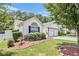 Charming home with well-manicured landscaping, green lawn, and a beautiful front yard at 3198 Liberty Commons Dr, Kennesaw, GA 30144