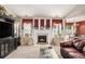 Comfortable living room featuring a cozy fireplace, built in shelves, and connection to dining area at 3198 Liberty Commons Dr, Kennesaw, GA 30144