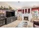 Comfortable living room featuring a cozy fireplace, built in shelves, and connection to dining area at 3198 Liberty Commons Dr, Kennesaw, GA 30144