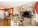 Open-concept living area features granite counters, modern appliances, and seamless flow into the living room with natural light at 3198 Liberty Commons Dr, Kennesaw, GA 30144