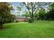 Expansive backyard featuring a brick home and mature trees, offering a private outdoor space at 4852 Pine Shadows Dr, Stone Mountain, GA 30088