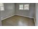 This bedroom features a hardwood floor and dual windows for natural light at 4852 Pine Shadows Dr, Stone Mountain, GA 30088