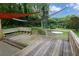 Wooden deck with built-in bench seating and overhead sunshades, ideal for relaxing outdoors at 4852 Pine Shadows Dr, Stone Mountain, GA 30088