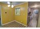 Bright dining room with a stylish lighting fixture, wood-look flooring, and a window bringing in natural light at 4852 Pine Shadows Dr, Stone Mountain, GA 30088