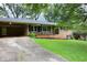 Brick home with a carport and well-manicured front lawn creates an inviting curb appeal at 4852 Pine Shadows Dr, Stone Mountain, GA 30088