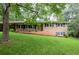 Charming brick home with a well-maintained lawn and mature trees provides comfortable living at 4852 Pine Shadows Dr, Stone Mountain, GA 30088