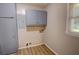 Laundry room includes blue cabinets and a window offering natural light at 4852 Pine Shadows Dr, Stone Mountain, GA 30088