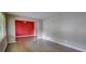 Spacious living room with hardwood floors and a red accent wall provides comfortable living space at 4852 Pine Shadows Dr, Stone Mountain, GA 30088
