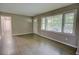 Bright living room features hardwood floors, neutral paint, and large windows overlooking the yard at 4852 Pine Shadows Dr, Stone Mountain, GA 30088