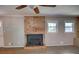 Living room with brick fireplace, wood-look flooring, and neutral walls provides a cozy space at 4852 Pine Shadows Dr, Stone Mountain, GA 30088